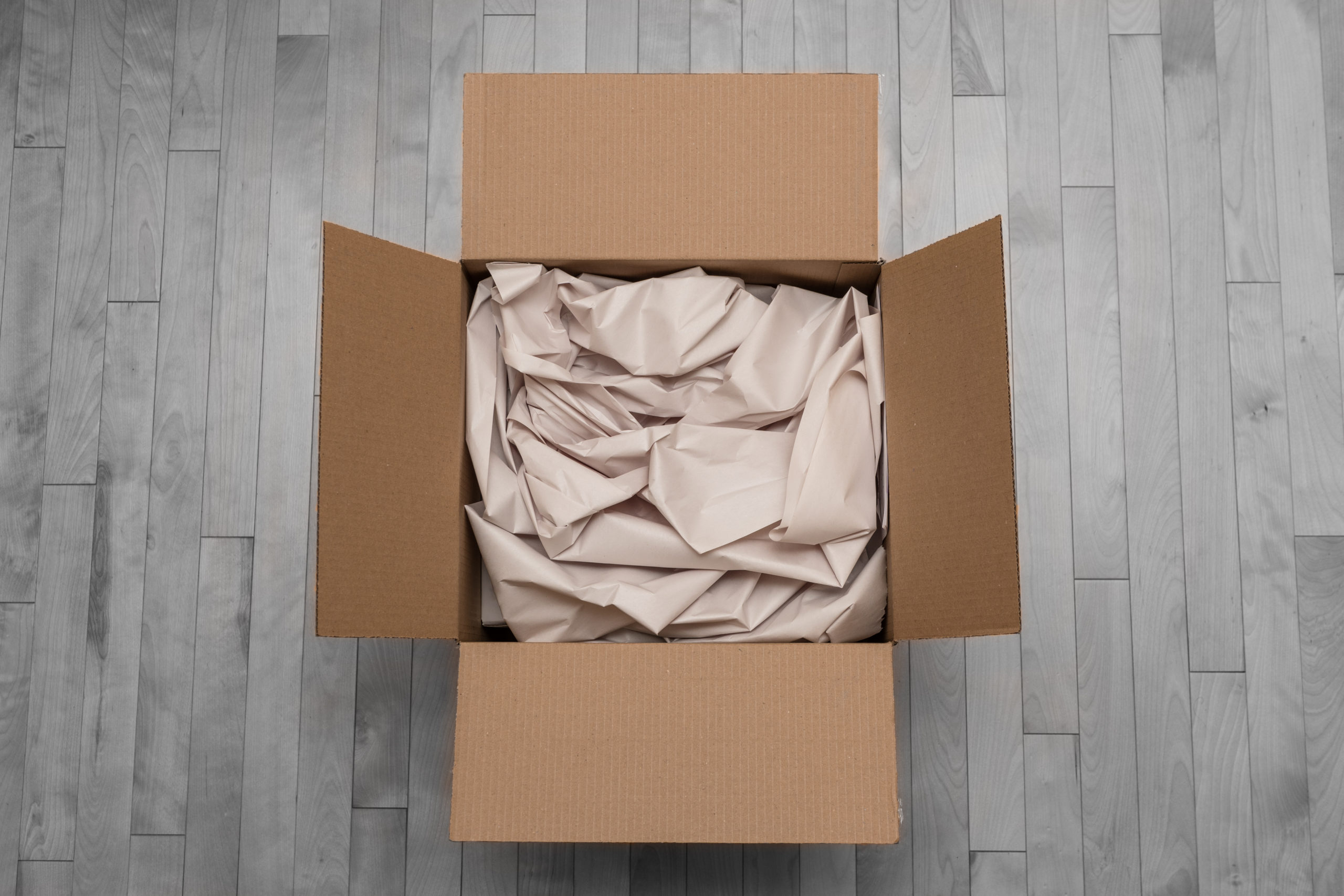 Cardboard box with paper packing material
